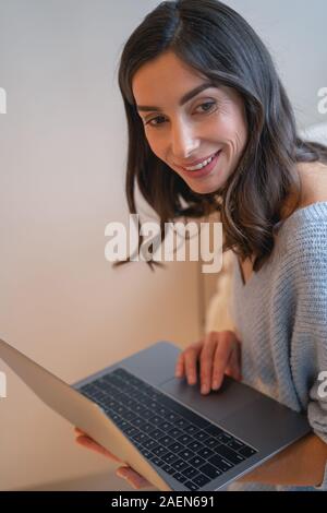 Happy woman working with laptop stock photo Banque D'Images