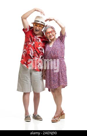 Happy senior couple making heart shape Banque D'Images