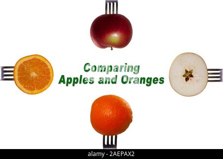 Des pommes et des oranges sur les fourches. Comparer des pommes et des oranges. Banque D'Images