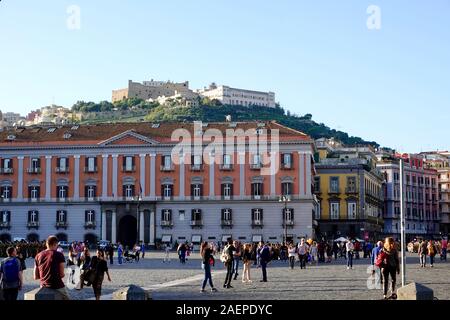 Voir des gens dans la la Piazza del Plebiscito et la forteresse médiévale, le château Sant'Elmo, située sur la colline au-dessus, Naples, Italie. Banque D'Images