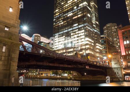 Belle nuit du temps à l'établissement de centre-ville de Chicago, le pont sur la rivière de marche avant avec gratte-ciel bâtiments en arrière-plan l'éclairage Banque D'Images