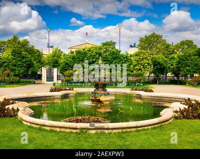 Scène pittoresque de Volksgarten avec fontaine et bâtiment du parlement autrichien. Printemps ensoleillé voir à Vienne, Autriche, Europe. Style artistique poster pr Banque D'Images