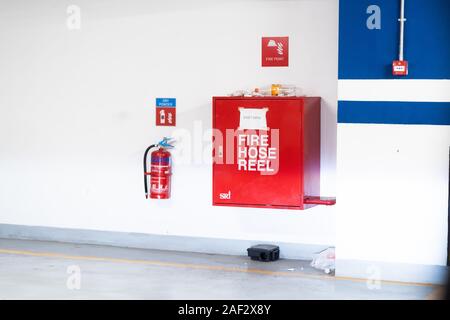 Les lances à incendie emballés à l'intérieur d'urgence rouge fort au mur Banque D'Images