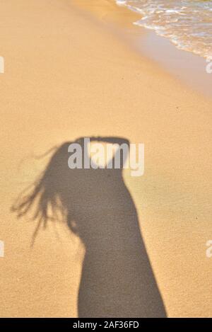 Ombre du photographe la fille dans le sable, silhouette dans le sable, les vagues Banque D'Images