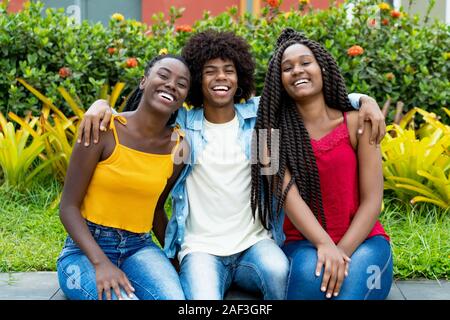 Groupe d'amis américains africains piscine en été Banque D'Images