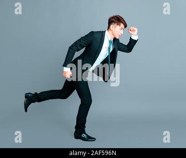 Happy young business man in motion Banque D'Images