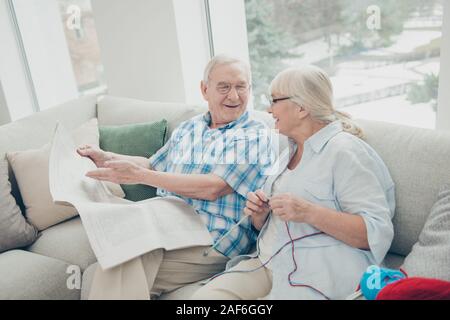 Portrait de son il qu'elle deux personnes Gai gai nice partenaires vie assis sur le divan lisant les nouvelles du monde du tricot papier blanc à la lumière de l'habillement Banque D'Images