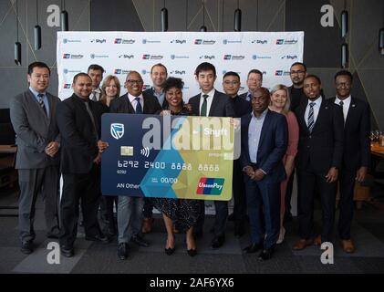 Johannesburg, Afrique du Sud. Dec 12, 2019. Les membres du personnel de la direction générale de l'Afrique International UnionPay et la Standard Bank of South Africa posent pour une photo de groupe dans la région de Johannesburg, Afrique du Sud, le 12 décembre 2019. La Standard Bank of South Africa a lancé la carte UnionPay jeudi pour les détenteurs d'un compte local pour plus de commodité en paiement en Chine. La carte est disponible à la fois sous forme virtuelle et physique de la banque et le Shyft app. L'app permet aux pré-chargés rands sud-africains d'être échangées en plusieurs devises, puis chargé dans une carte UnionPay physique. Crédit : Chen Cheng/Xinhua/Alamy Live News Banque D'Images