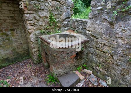 Le chauffe-eau dans l'un des cottages en ruine, maintenant sans abri et ont été remis par la nature dans le village abandonné de Tyneham, Dorset, England, UK Banque D'Images