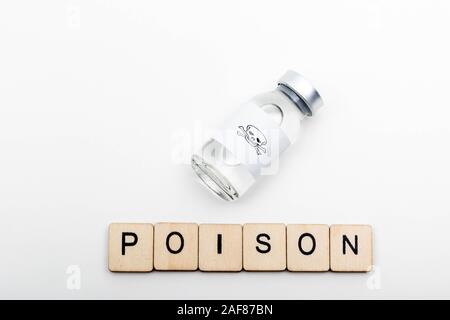 Un flacon de verre medical avec une tête de mort sur un fond blanc avec un écriteau Poison Banque D'Images Un flacon de verre medical avec une tête de mort sur un fond blanc avec un écriteau Poison Banque D'Images