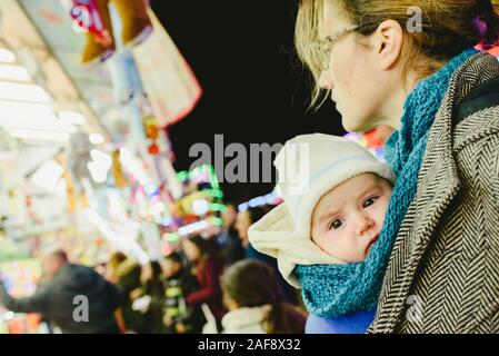 Transport bébé dans une écharpe kangourou par sa mère. Banque D'Images