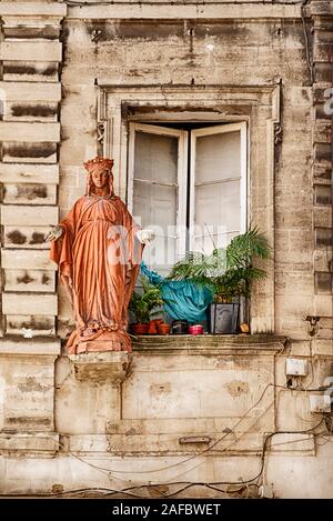 Une statue d'un saint est placé à l'extérieur d'un windows dans la ville d'Avignon dans le sud de la France. Banque D'Images