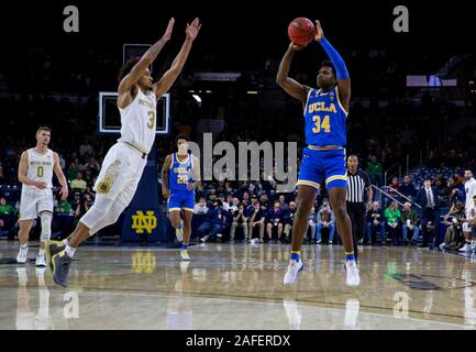 South Bend, Indiana, USA. 14 Décembre, 2019. Garde d'UCLA David Singleton (34) tire la balle comme Notre Dame guard Prentiss Hubb (3) défend l'action de jeu de basket-ball de NCAA pendant entre l'UCLA Bruins et la Notre Dame Fighting Irish à Purcell Pavilion à Joyce Center à South Bend, Indiana. Notre Dame de l'UCLA défait 75-61. John Mersits/CSM/Alamy Live News Banque D'Images