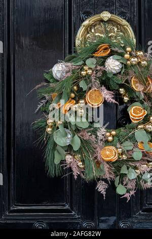 Couronne de Noël sur une maison en bois noir porte. Londres, Angleterre Banque D'Images