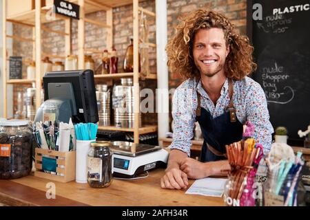 Portrait de l'homme propriétaire d'épicerie en plastique durable gratuitement derrière Bureau de vente Banque D'Images