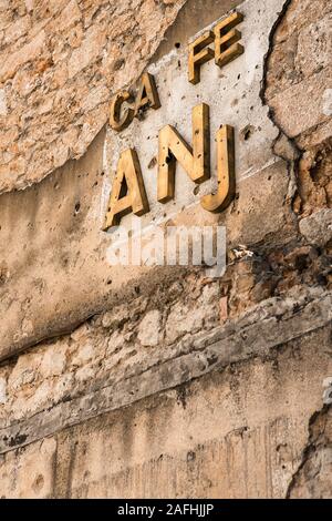 Mostar, Bosnie-Herzégovine, 13 Octobre 2007 : Un caffe détruit signe sur un mur d'un bâtiment plein de vieux trous d'obus dans la région de Mostar, Bosnie-Herzégovine Banque D'Images