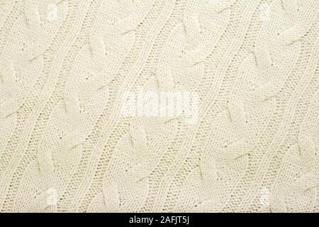 La texture de la laine tricot beige pour l'arrière plan. Close up of White la trame modèle pour la conception. Pull chaud beige fond textile Banque D'Images