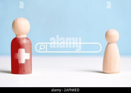 La notion d'abstract médecin recherche sur l'Internet en ligne. Figurines en bois avec une bande de rechercher et d'une loupe signe. Close up. Banque D'Images