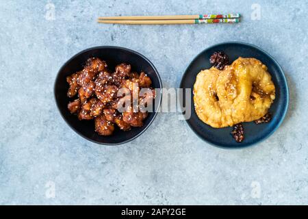 Général chinois fait maison Cuisine asiatique poulet frit et GRT caramélisés beignets d'ananas à la cannelle et les graines de sésame. La nourriture traditionnelle. Banque D'Images