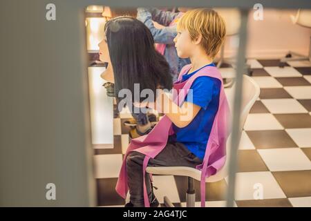 Garçon coiffeur, jour de choix de profession, jouer chez le coiffeur dans le salon de beauté pour enfants, coiffeur, coiffure, coiffure emploi Banque D'Images