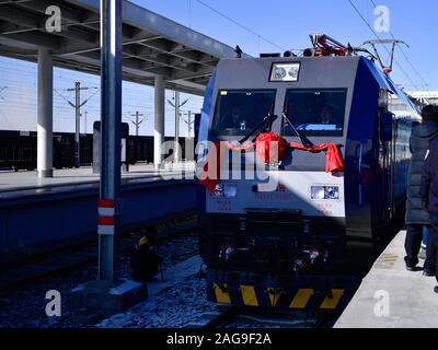 Golmud, dans la province de Qinghai en Chine. Dec 18, 2019. Un train part de la gare de Golmud Golmud City, au nord-ouest de la province de Qinghai en Chine, 18 décembre 2019. Un nouveau chemin de fer reliant la ville de Dunhuang, dans le nord-ouest de la Chine, la province de Gansu et Golmud city, dans le nord-ouest de la Chine, la province du Qinghai, complètement ouvert, mercredi, selon China Railway. Les 671 km qui est une importante ligne de liaison entre le chemin de fer Qinghai-Tibet et le fer Lanzhou-Xinjiang. Il permet aux trains de fonctionner à 120 km par heure, a déclaré la société. Credit : Zhang Long/Xinhua/Alamy Live News Banque D'Images