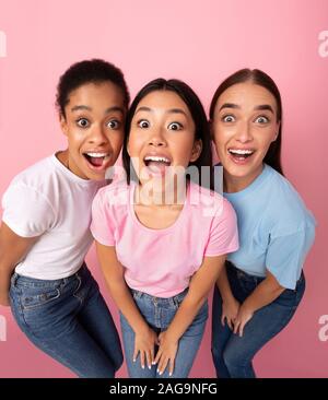 Trois Funny Girls Looking at Camera, permanent, High-Angle fond rose Banque D'Images