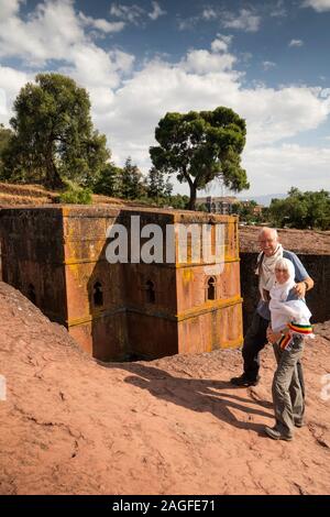 L'Éthiopie, région d'Amhara, Lalibela, senior couple de touristes au-dessus de Bet Giyorgis, St George's Lailibela rock découvert seulement l'église de coupe Banque D'Images