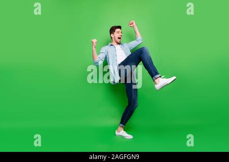 La taille du corps sur toute la longueur de la photo s'excité positif homme extatique se réjouir avec sa victoire lors du concours couleur vert plus isolés Banque D'Images