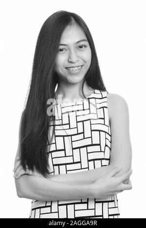 Close up of young happy Asian teenage girl smiling with arms crossed Banque D'Images