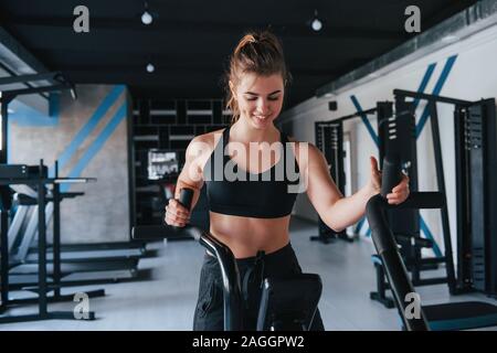 Toujours positif girl ayant l'exercice. Photo de belle femme blonde dans la salle de sport à son temps de fin de semaine Banque D'Images