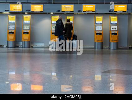 20 décembre 2019, Hessen, Frankfurt/Main : Les passagers sont au self-check-in desk in Terminal 1 de l'aéroport. Une augmentation du nombre de passagers est attendue dans les prochains jours. Photo : Boris Roessler/dpa Banque D'Images