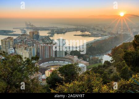 Coucher de soleil sur Malaga. La ville sur la Costa del sol espagnole en soirée avec une vue panoramique sur le port, les maisons, les arbres, les arènes Banque D'Images