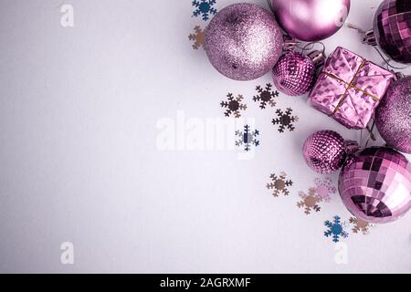 Vacances de Noël composition, vue de dessus violet-rose-violet décorations de Noël sur fond bleu-blanc avec copie espace pour le texte. Mise à plat. L'hiver Banque D'Images