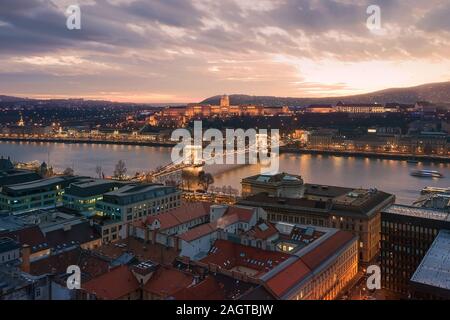 Coucher de soleil paysage urbain de Budapest avec le Danube, le pont des chaînes Széchenyi, Buda caslle, Varkert bazaar et Sandor palace. Banque D'Images