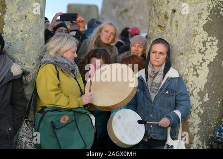 Wiltshire, Royaume-Uni. Dec 22, 2019. Carnavaliers à Stonehenge bienvenue l'aube sur le solstice d'hiver, le jour le plus court de l'année. Le soleil s'est levé à 08;04h00 et le Solstice officiel dans l'hémisphère Nord était à 04.19h le dimanche 22 décembre 2019. Les païens de célébrer le plus grand nombre d'heures d'obscurité et le retour du soleil comme jours s'allongent jusqu'à ce que le solstice d'été. Crédit : MARTIN DALTON/Alamy Live News Banque D'Images