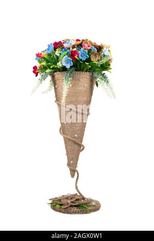 Tricoté décoratif des fleurs dans un vase conique isolé sur fond blanc. Couture, passe-temps. Banque D'Images