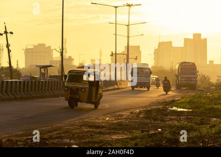 Déménagement la circulation durant le lever du soleil d'or dans la ville de Chennai, Inde du Sud Banque D'Images