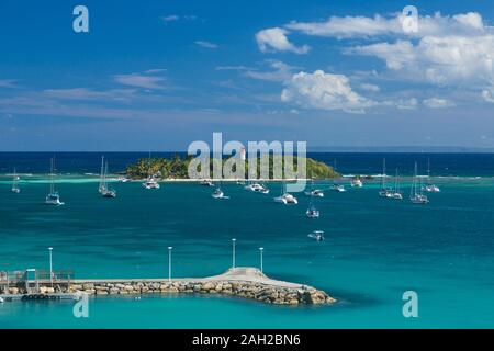 Voiliers à l'ancre par l'Ilet du gosier phare comme vu de la banlieue de Pointe-à-Pitre sur la Guadeloupe. La grande île de Marie-Galante est sur Banque D'Images