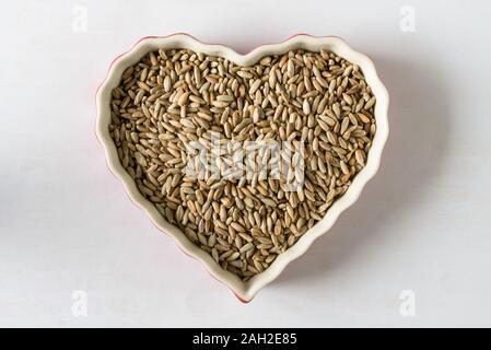 Mouture de grains entiers baies de seigle en forme de coeur Banque D'Images