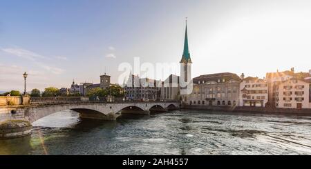 La Suisse, Canton de Zurich, Zurich, Munsterbrucke bridge au coucher du soleil avec en arrière-plan l'église Fraumunster Banque D'Images