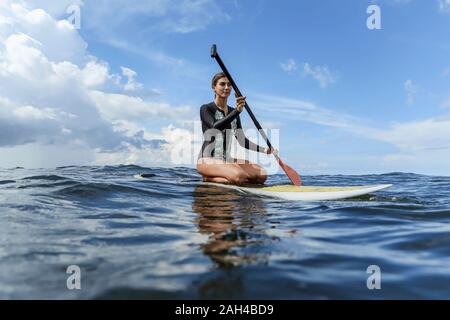 Femme SUP surfer, Bali, Indonésie Banque D'Images