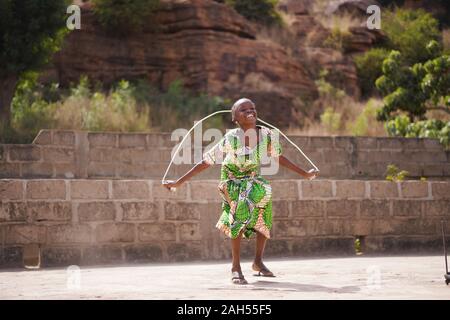 Peu de petite fille africaine s'amusant avec sa corde à sauter Banque D'Images