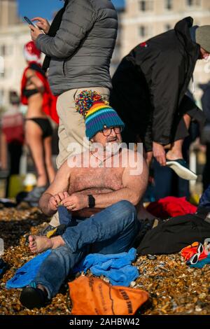 25 décembre 2019 : Brighton, Royaume-Uni. 25 décembre 2019. Des centaines de personnes se rassemblent sur la plage de Brighton pour leur journée annuelle de Noël nager. En dépit de l'augmentation des problèmes de sécurité et du Conseil les grandes vagues de la mer, plusieurs nageurs ont pris part cette année à la trempette de Noël au large de la plage de Brighton dans leurs bikinis, shorts de natation, et Santa Claus Crédit : Matt Duckett tenues/IMAGESLIVE/ZUMA/Alamy Fil Live News Banque D'Images