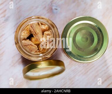 Pot en verre avec cadre naturel préservé le filet de bonite dans de l'huile sur table en bois Banque D'Images