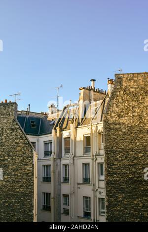 Vue verticale de la toiture d'un bâtiment ancien dans le 11ème arrondissement sur la Rive Droite dans le centre historique de Paris contre le ciel bleu, France Banque D'Images