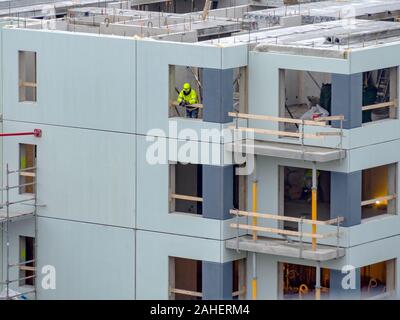 Builders avec grue à étages de construction maison. Hiver ou automne fond. Les travailleurs des constructeurs avec grue sur un appartement maison. Sous ciel bleu du concept d'entreprise. Banque D'Images