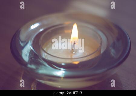 Bougie basse burns dans un chandelier en verre ronde, gros plan. Banque D'Images