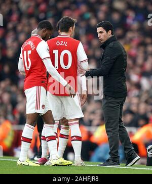 Gestionnaire d'Arsenal Mikel Arteta (à droite) parle de Mesut Ozil à partir de la ligne de touche lors de la Premier League match à l'Emirates Stadium, Londres. Banque D'Images