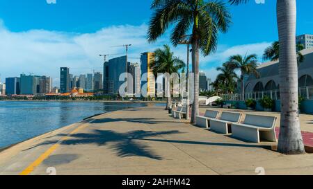 Luanda, Angola - 15 décembre 2019: Les gens marchant une journée ensoleillée à la baie de Luanda. Illustration éditoriale. Banque D'Images