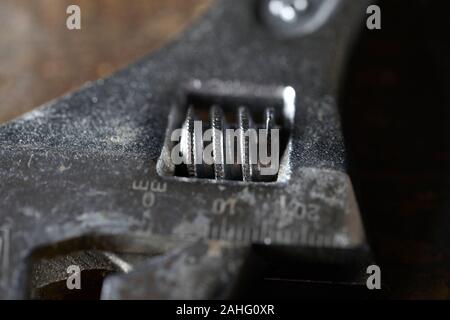 Clé ajustable isolé sur fond de bois . Macro photographie Banque D'Images